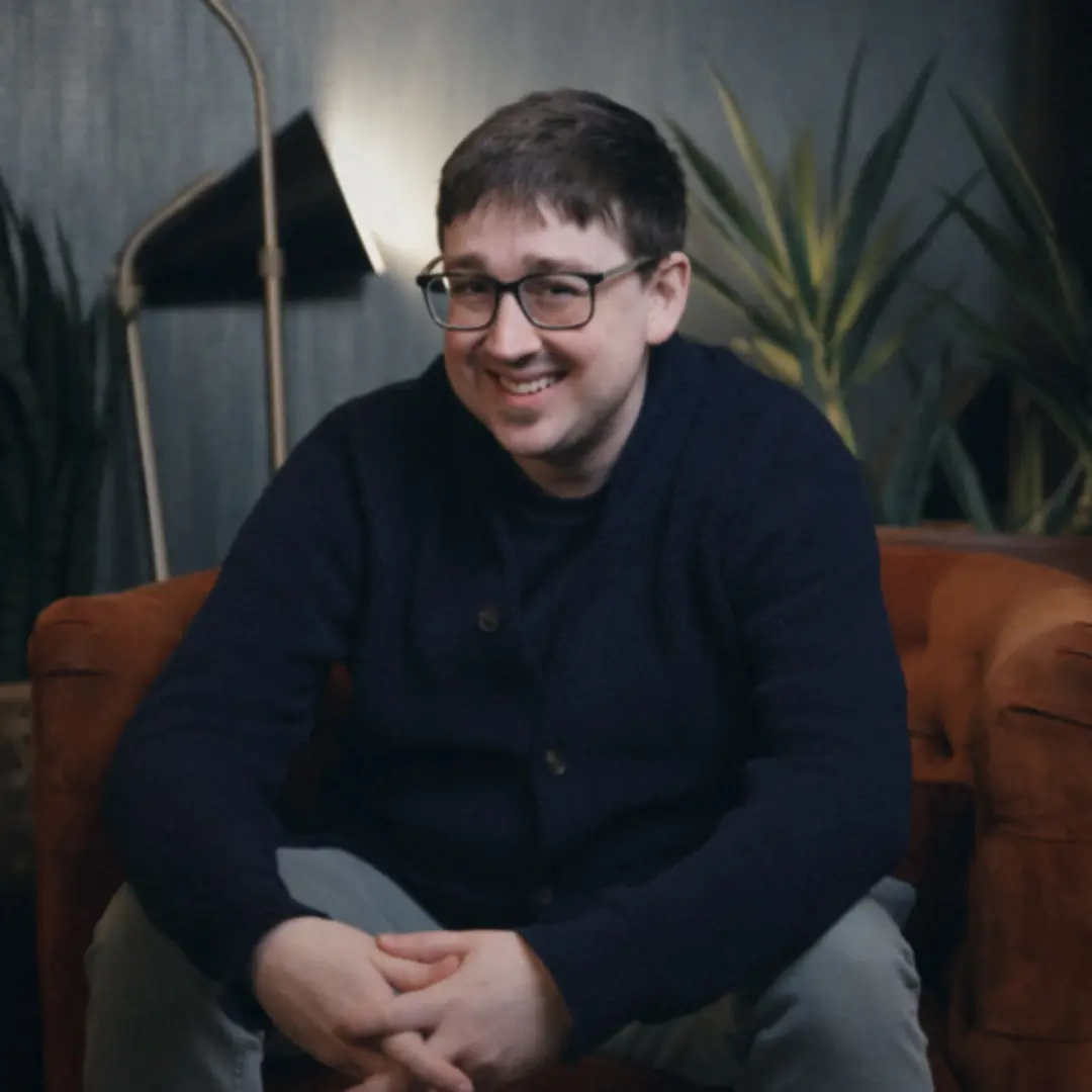 Justin Cypret in an orange armchair